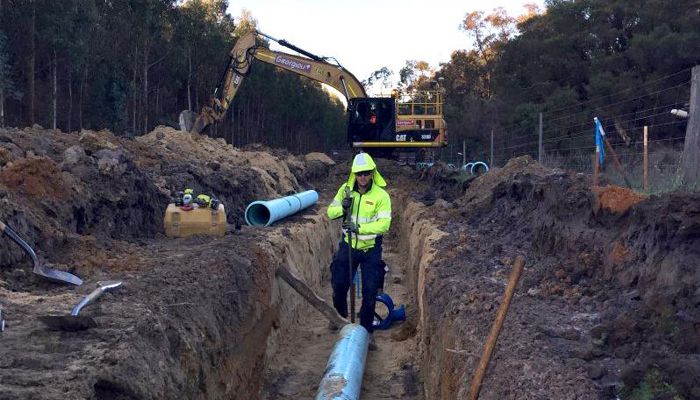 Worker laying down pipes for the Denmark pipeline