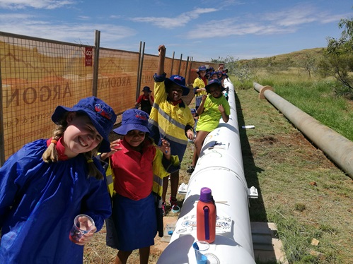 Students from Wickham Primary School painting a Water Corporation pipeline in Karratha for World Water Day