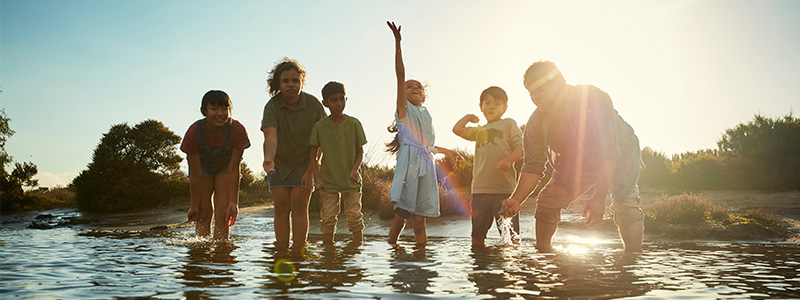 Children and adults playing in the water