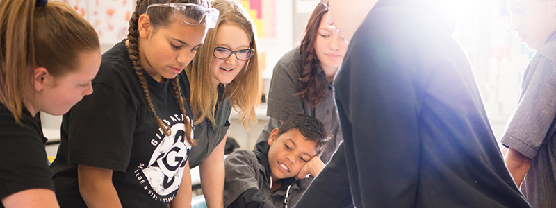 Students in a classroom looking at a diagram