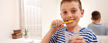 Child brushing teeth in the bathroom