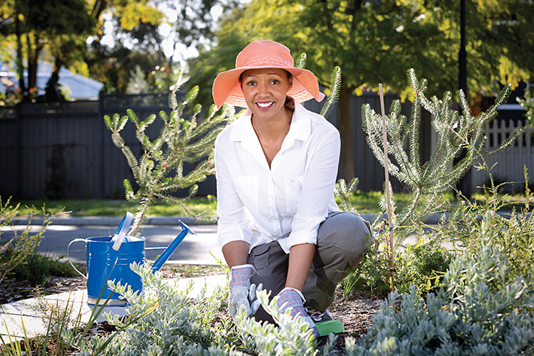 Female gardening in her waterwise verge