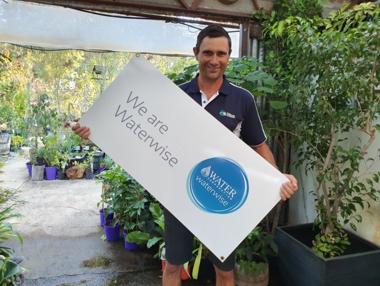 Garden nursery owner with waterwise endorsed sign