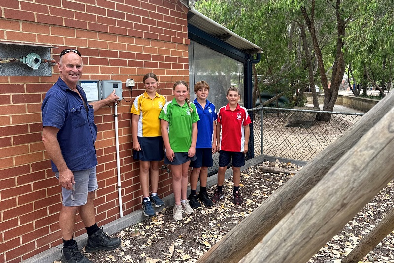 Dunsborough Primary School gardener Todd Hadden shows Year 6 students Eloise Brown, Lottie Reid, Seb Fairclough and Archie Whiteland how the high-tech system uses satellite data to control watering