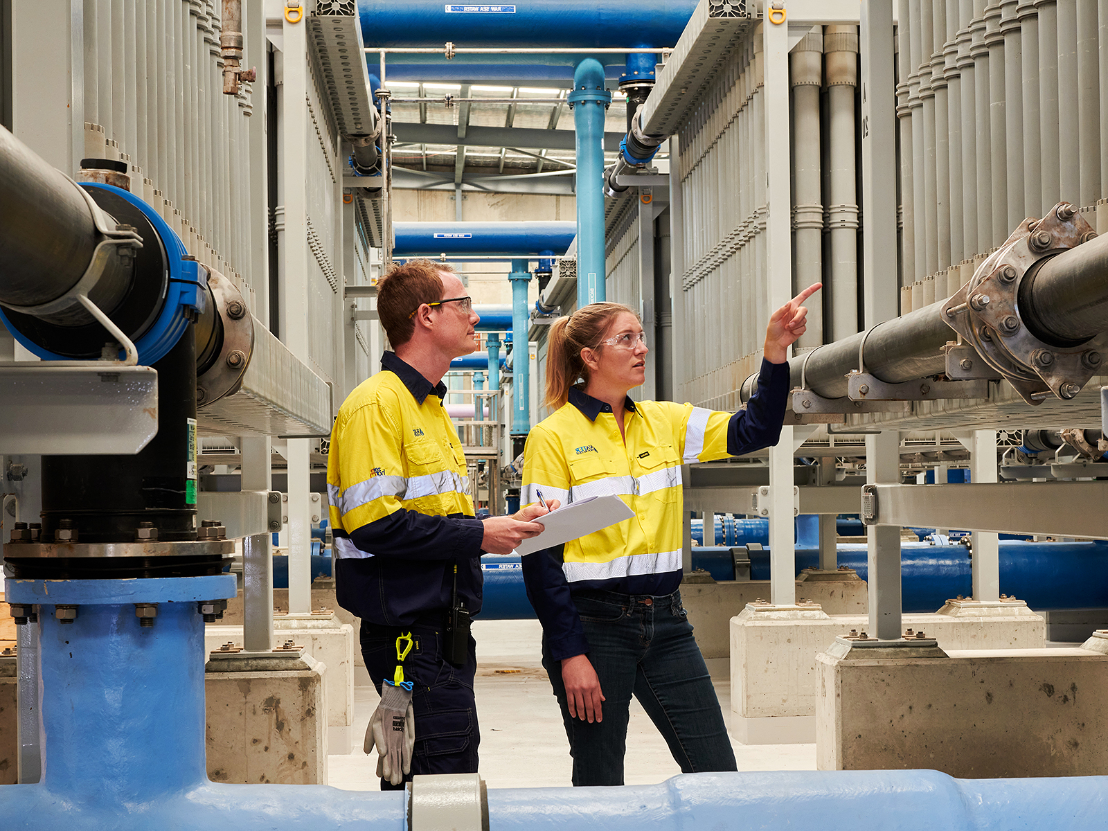 Image of two colleagues working together inside a desaliniation plant