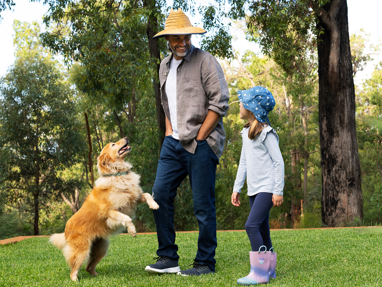 Image of employee playing with do and daughter