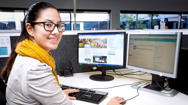 Water Corporation staff member sitting by workstation computer