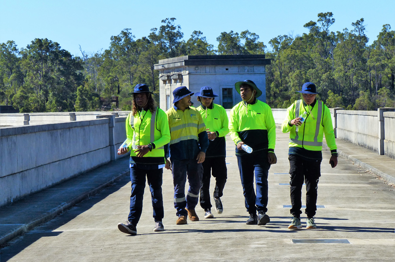 Image of Nick Brahim and students from Geraldton Clontarf Academy walking at Water Corporation’s Canning Dam