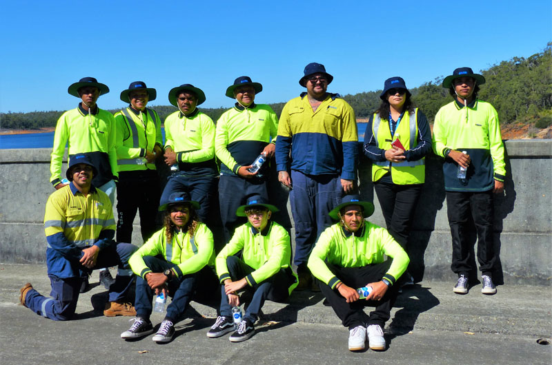 Image of Nick Brahim and students from Geraldton Clontarf Academy standing in front of Water Corporation’s Canning Dam
