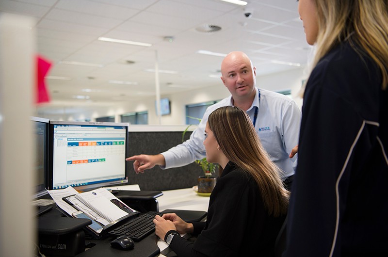 Image of Water Corporation colleagues working together around a computer