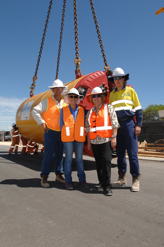 Alkimos wastewater treatment plant staff standing by tunnel boring machine.