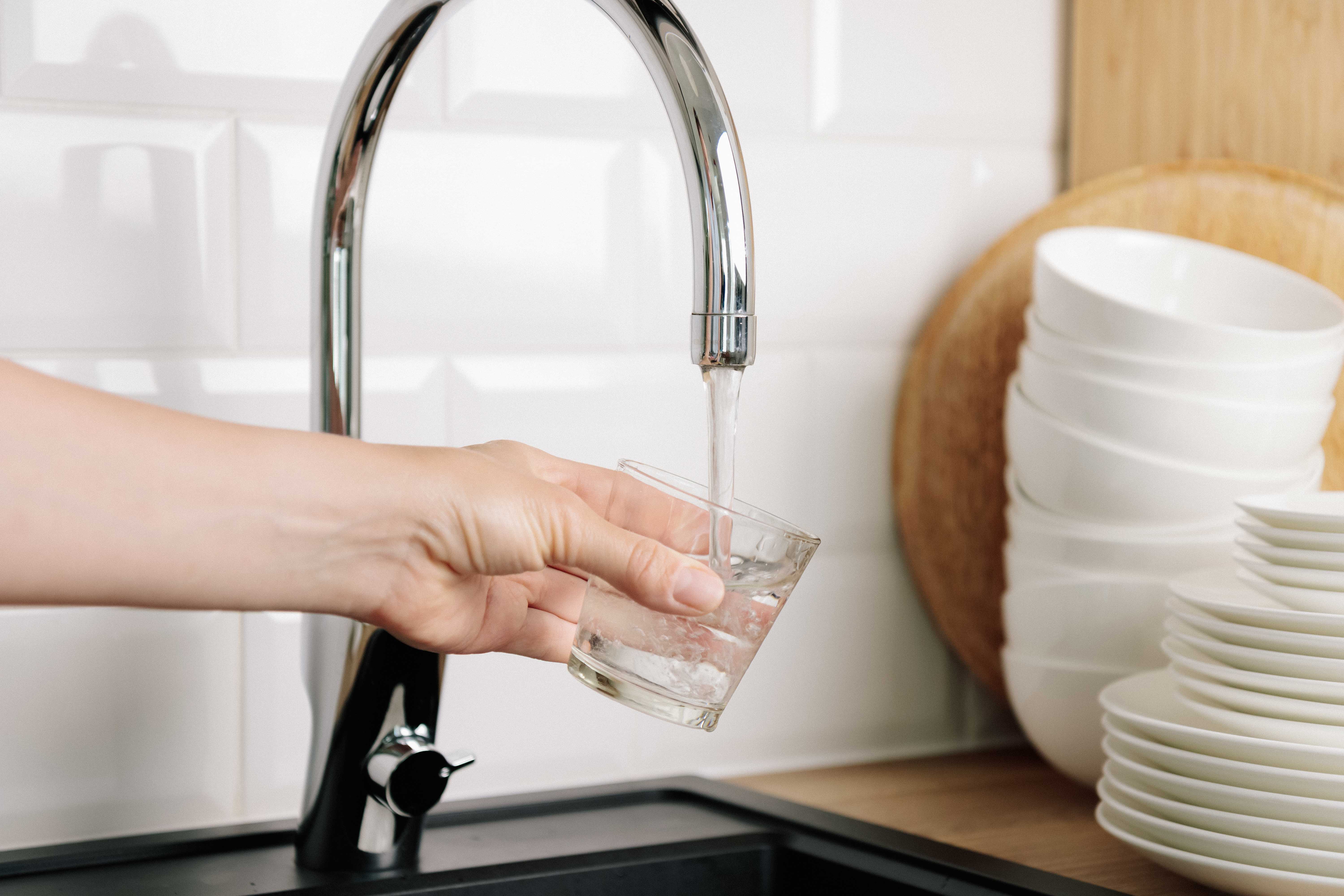 filling cup of water in faucet