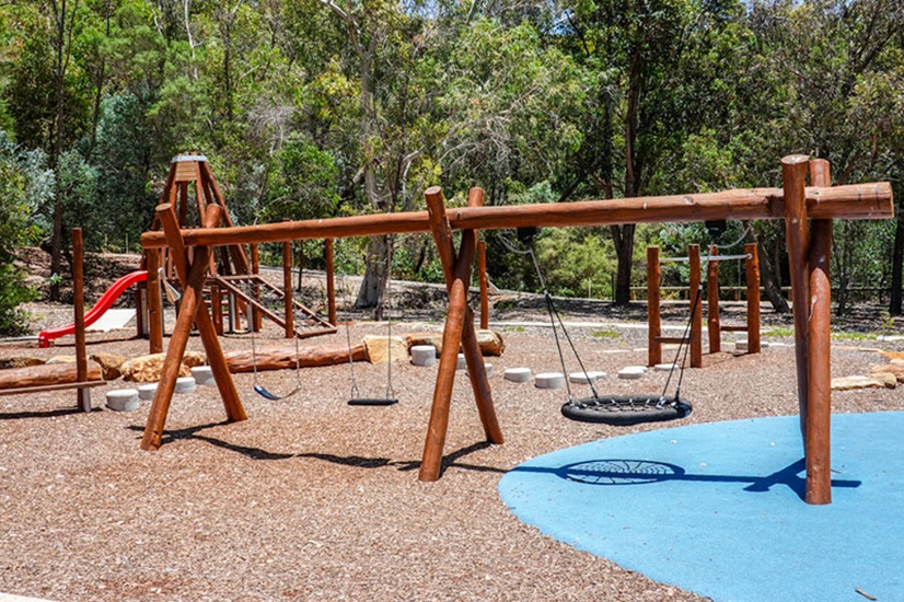 A playground swing made of timber logs at Churchman Brook Dam