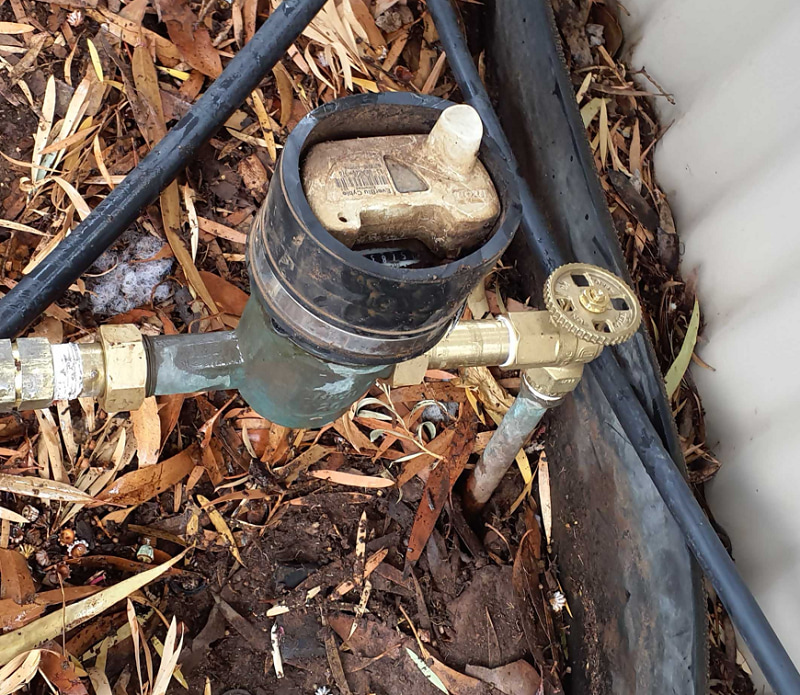 A standard water meter with a quarter-turn water mains tap