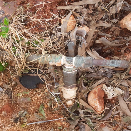 A meter that shows non-compliant pipe work on the outlet. A “T” connection has been made within 1 metre of the outlet and PVC pipework.