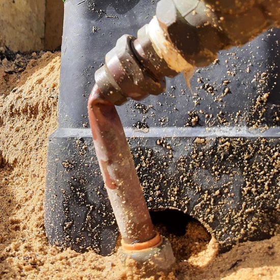 A water meter with bent, damaged pipework