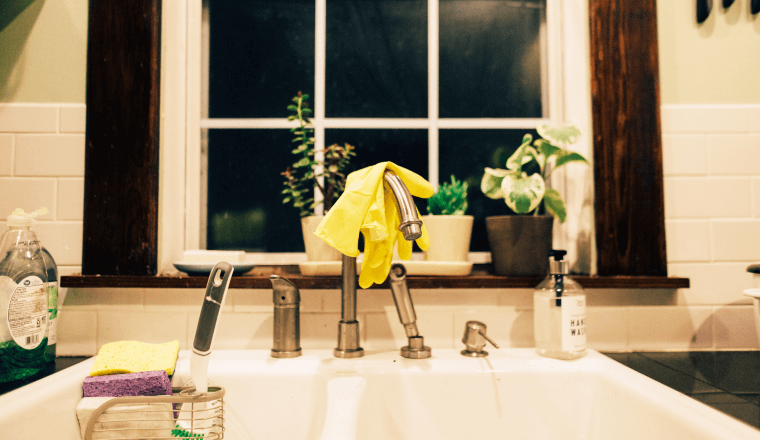 Rubber gloves hanging on the kitchen faucet
