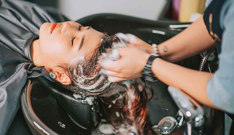 Image of a woman getting her hair washed in a salon