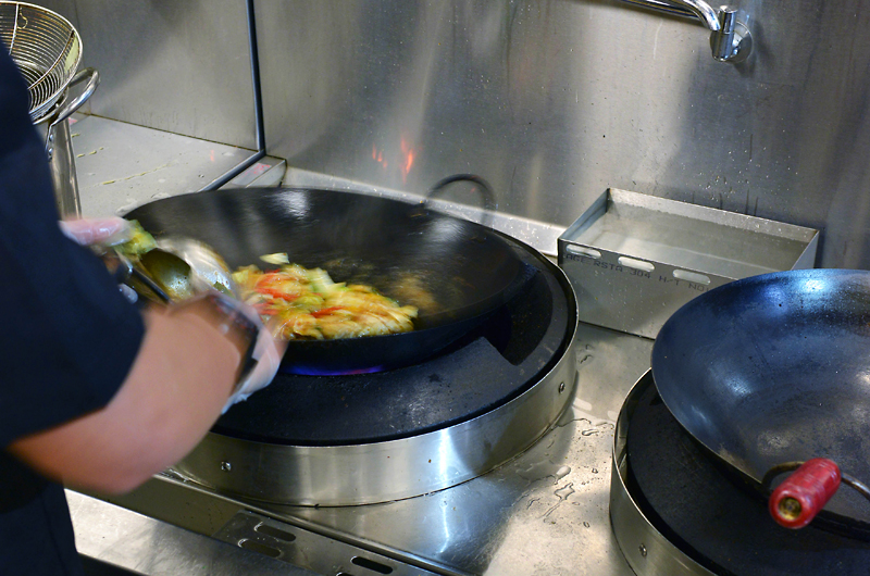Waterless wok being used to cook noodles and vegetables
