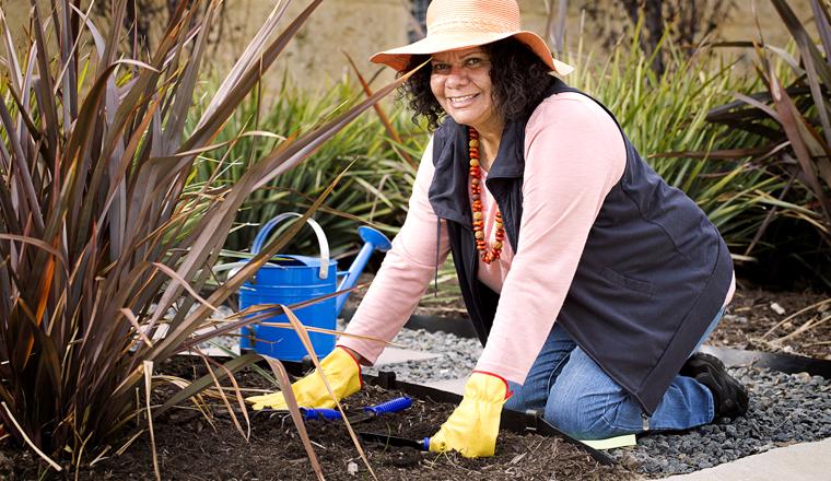 Woman planting in garden bed