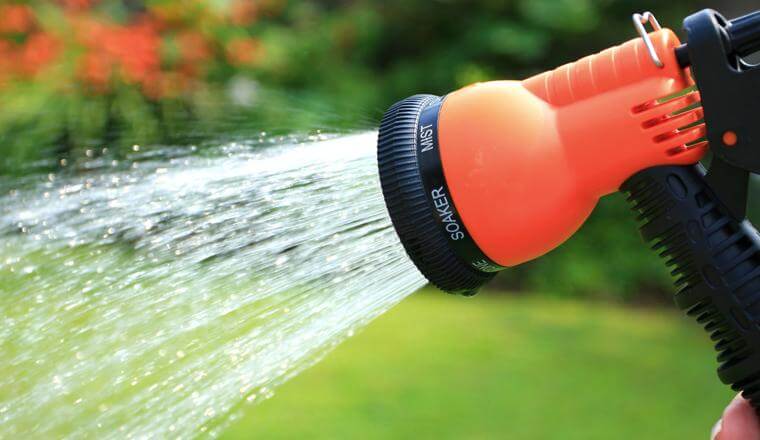 Garden hose with water spraying out
