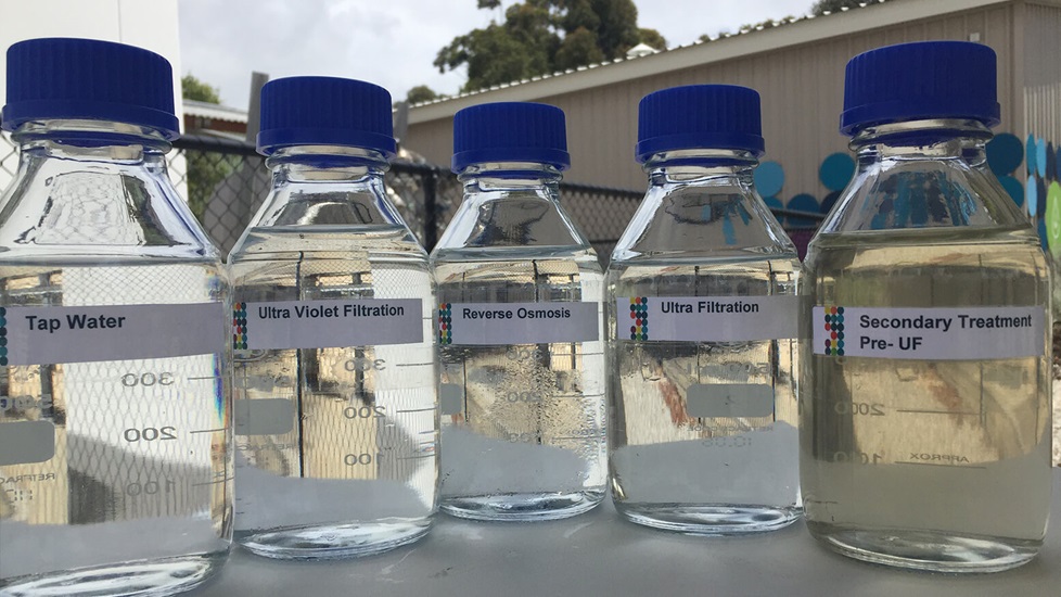 Bottles of water showing how it looks at the different stages of water recycling