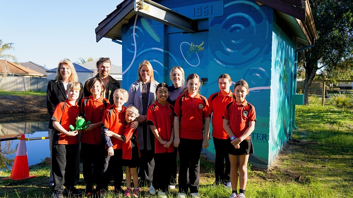 Group shot in front of transformed wastewater pump station