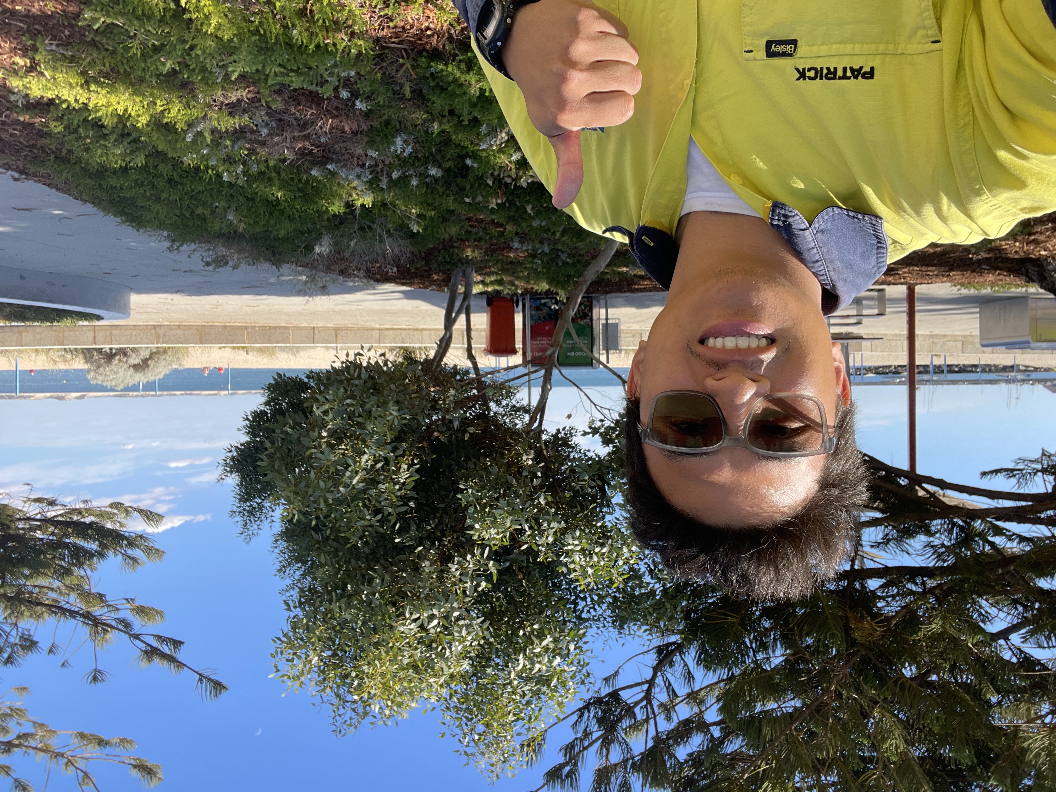 Patrick in his workplace with nature in the background wearing hivis