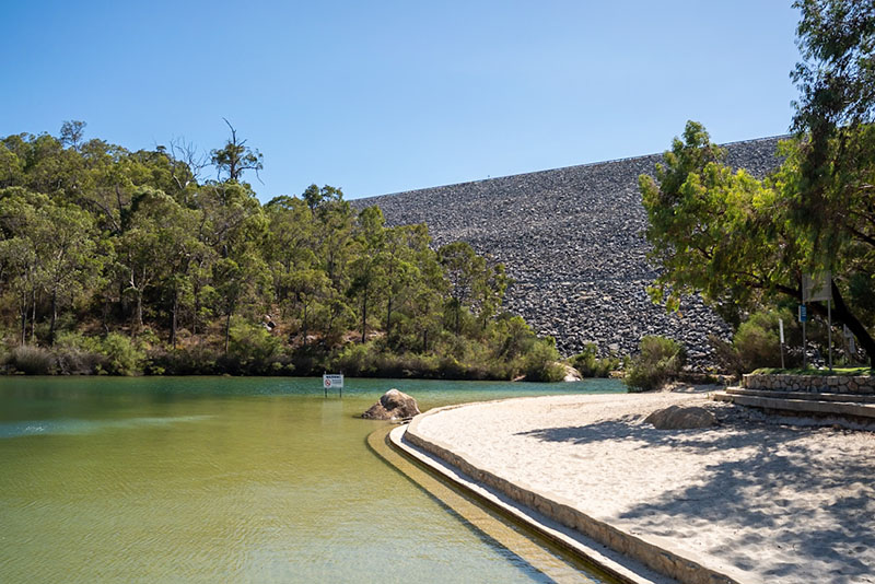 A sandpit with steps leads towards the water's edge of the lake at North Dandalup Dam