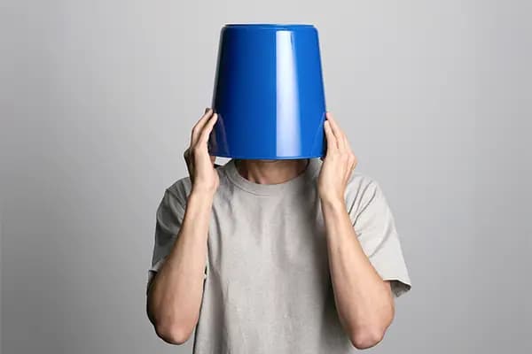 a man with a bucket on its head
