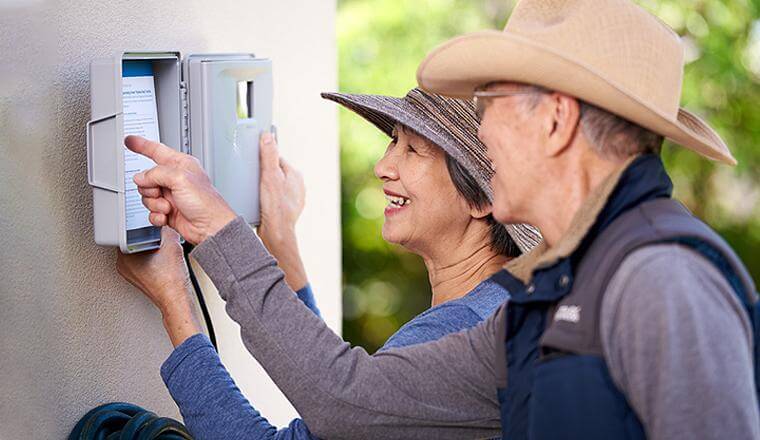 Couple adjusting irrigation controller