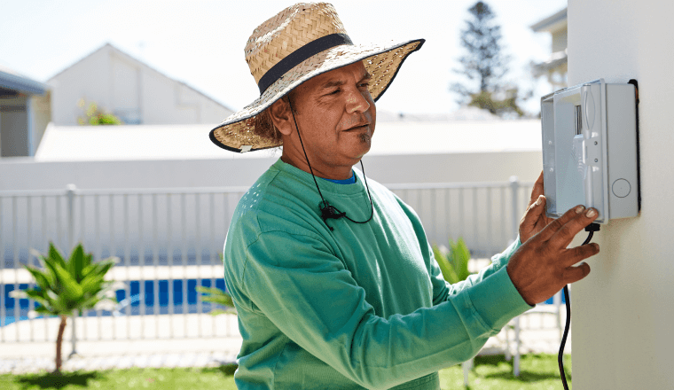 Man adjusting irrigation controller